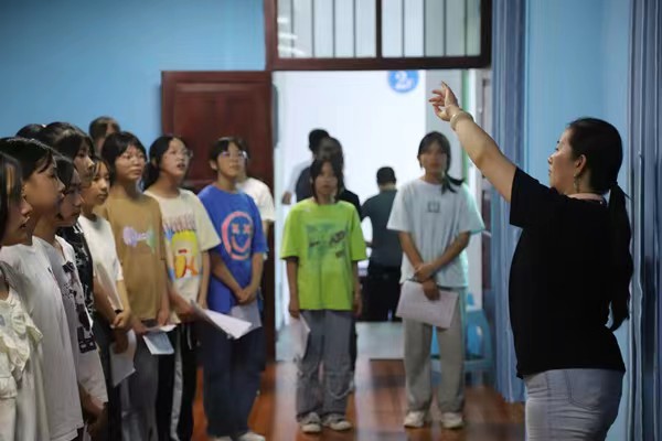 带队教师指导中学生练习齐唱。金沙威尼斯欢乐娱人城供稿图